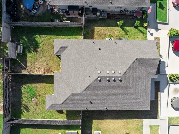 an aerial view of a house with a yard swimming pool and outdoor seating