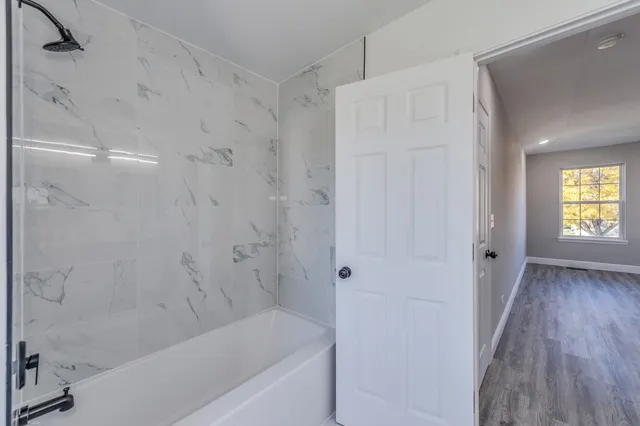 a bathroom with a bathtub and shower