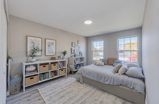 a bedroom with a bed furniture and windows