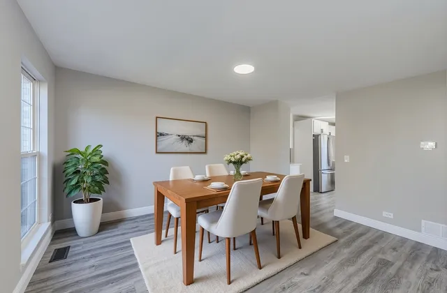 a view of a dining room with furniture and wooden floor