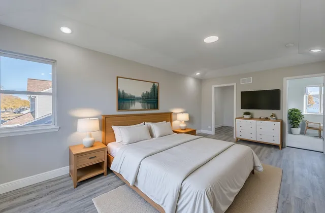 a bedroom with a bed and a flat screen tv