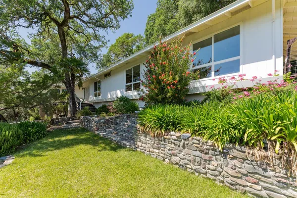 a front view of a house with garden