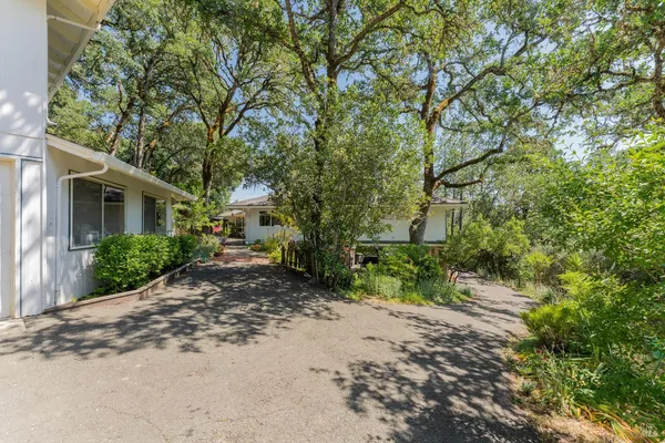 a view of a house with a tree in the background