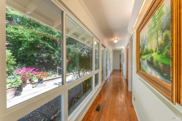 a view of a room with wooden floor and outdoor space