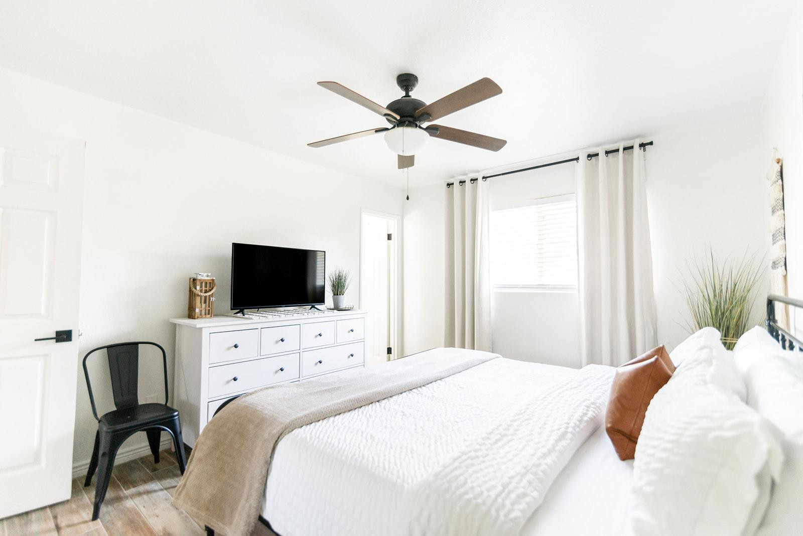 7435 East Granada Road Scottsdale, AZ 85257 - Photo 19 of 28 a bedroom with a bed and a flat screen tv