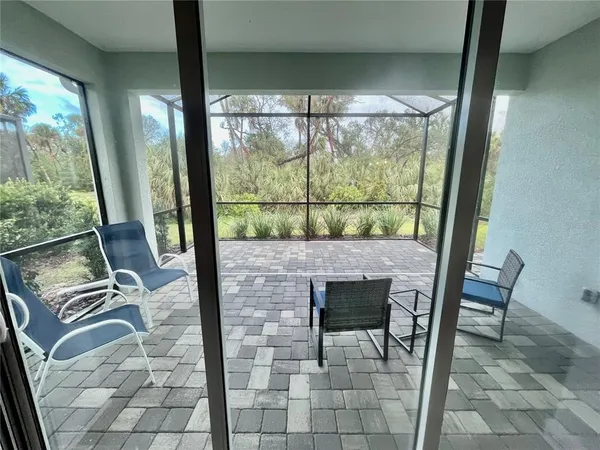 a view of a chairs and table in the balcony