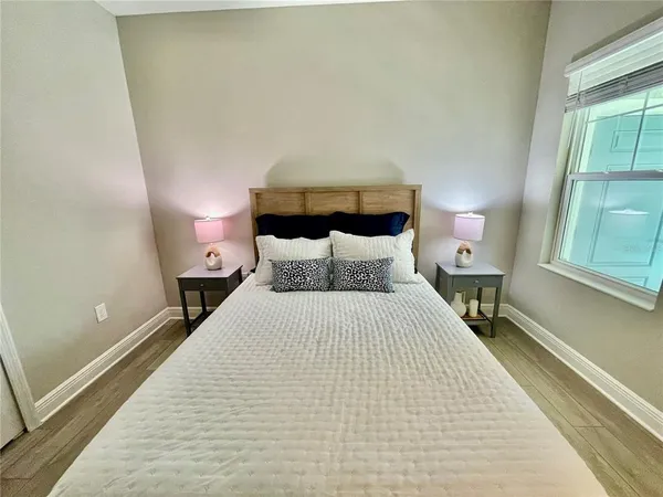 a bedroom with a bed and window