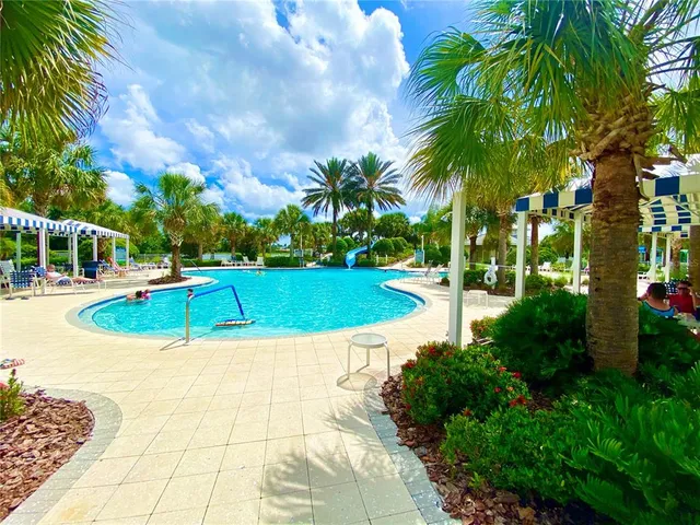 a view of a swimming pool with an outdoor space and seating area