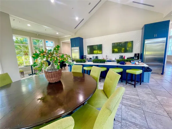 a view of a dining room with furniture and a potted plant
