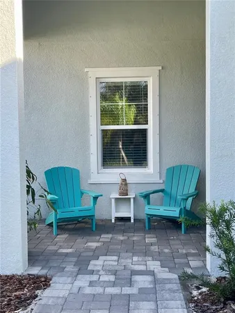 a view of a house with backyard and sitting area