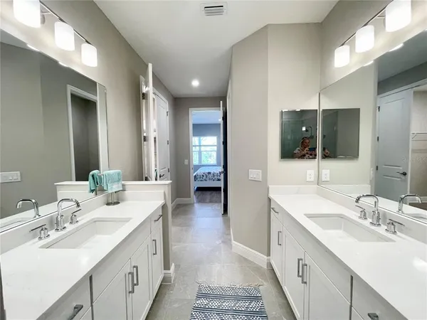 a bathroom with a sink double vanity and a mirror