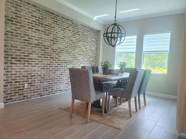 a dining room with furniture window wooden floor and a chandelier
