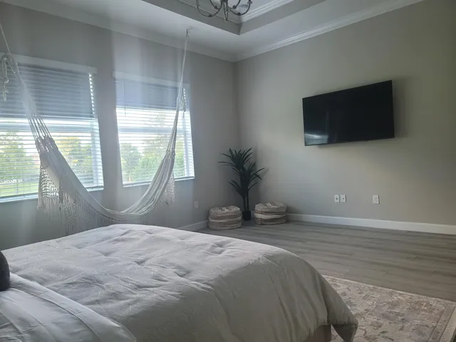 a bedroom with a bed and a flat screen tv