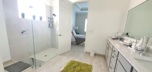a bathroom with a granite countertop sink a toilet and shower