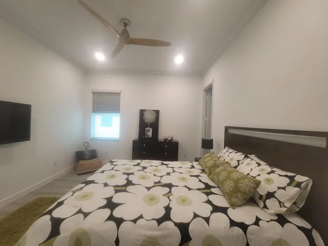 a bedroom with a bed and a flat screen tv