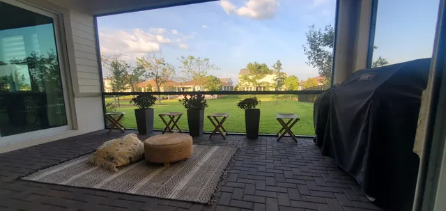 a view of a balcony with lake view and a large window