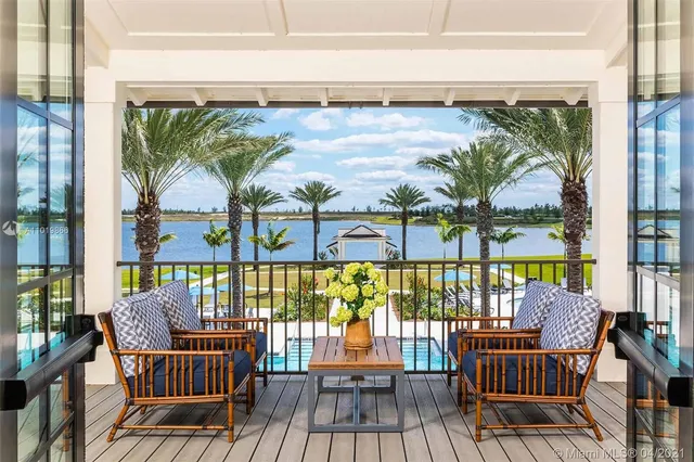 a view of a balcony with furniture and wooden floor