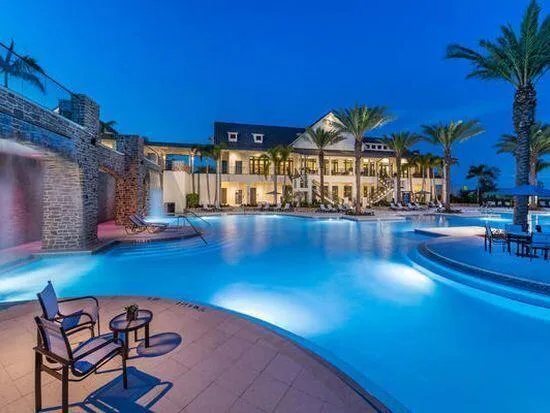 a view of a swimming pool with outdoor seating