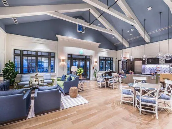 a living room with lots of furniture and kitchen view
