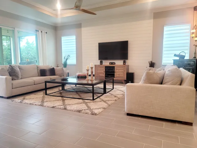 a living room with furniture and a flat screen tv