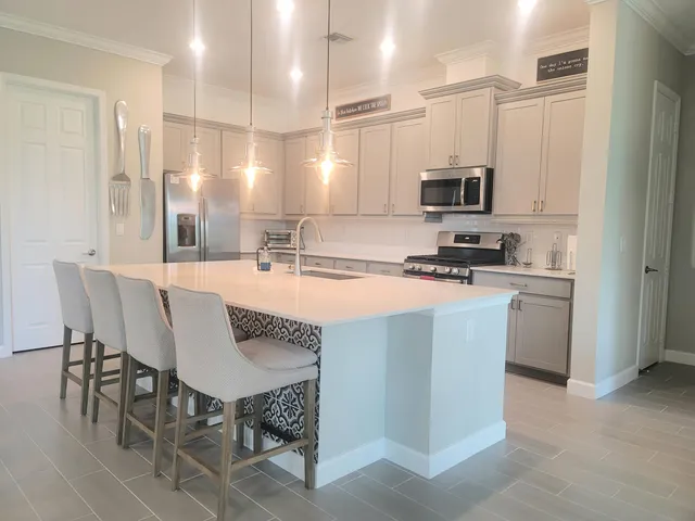 a kitchen with kitchen island a sink table and chairs
