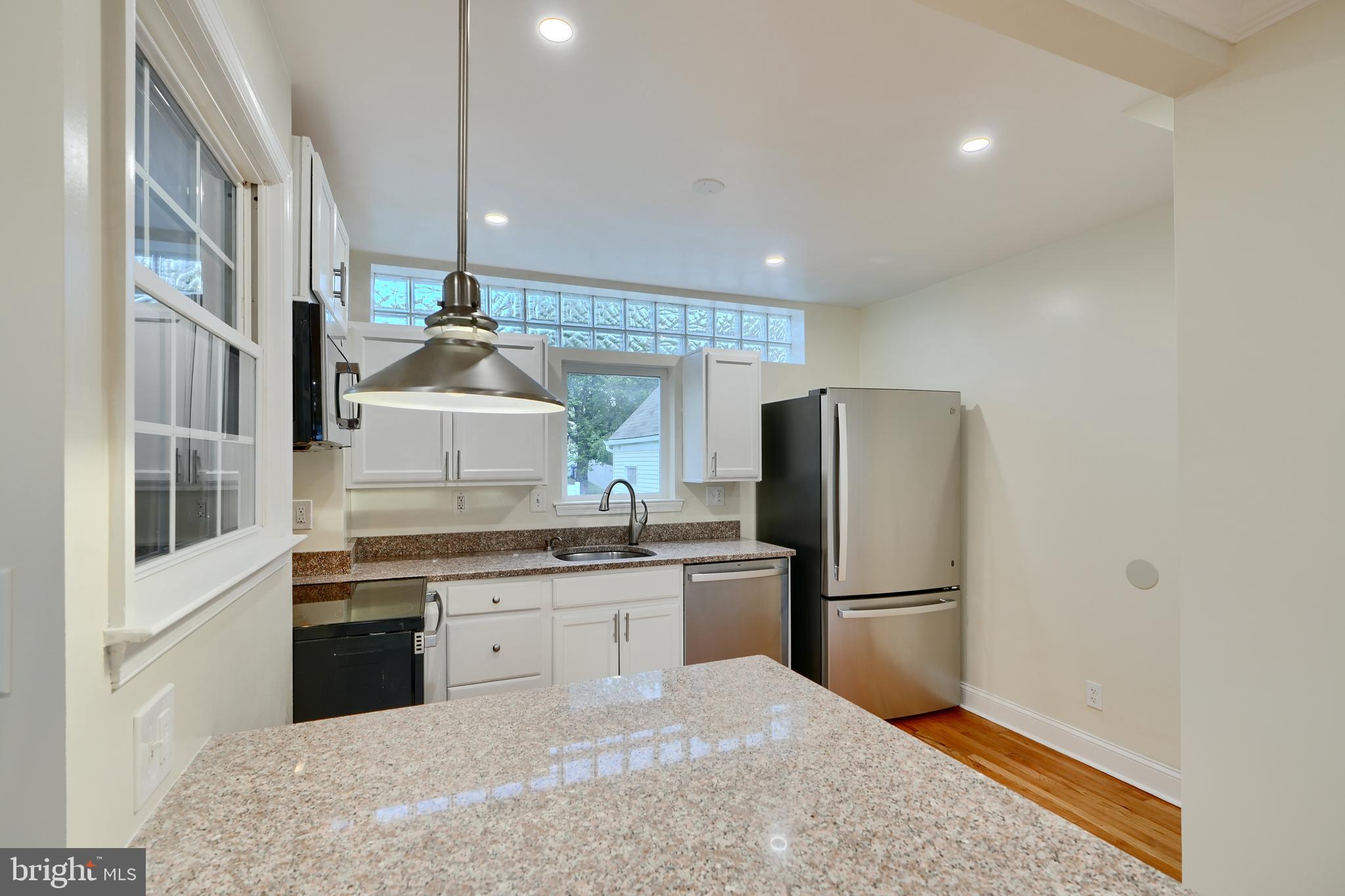 6409 Eastern Parkway Baltimore, MD 21214 - Photo 11 of 56 a kitchen with stainless steel appliances granite countertop a refrigerator sink and cabinets