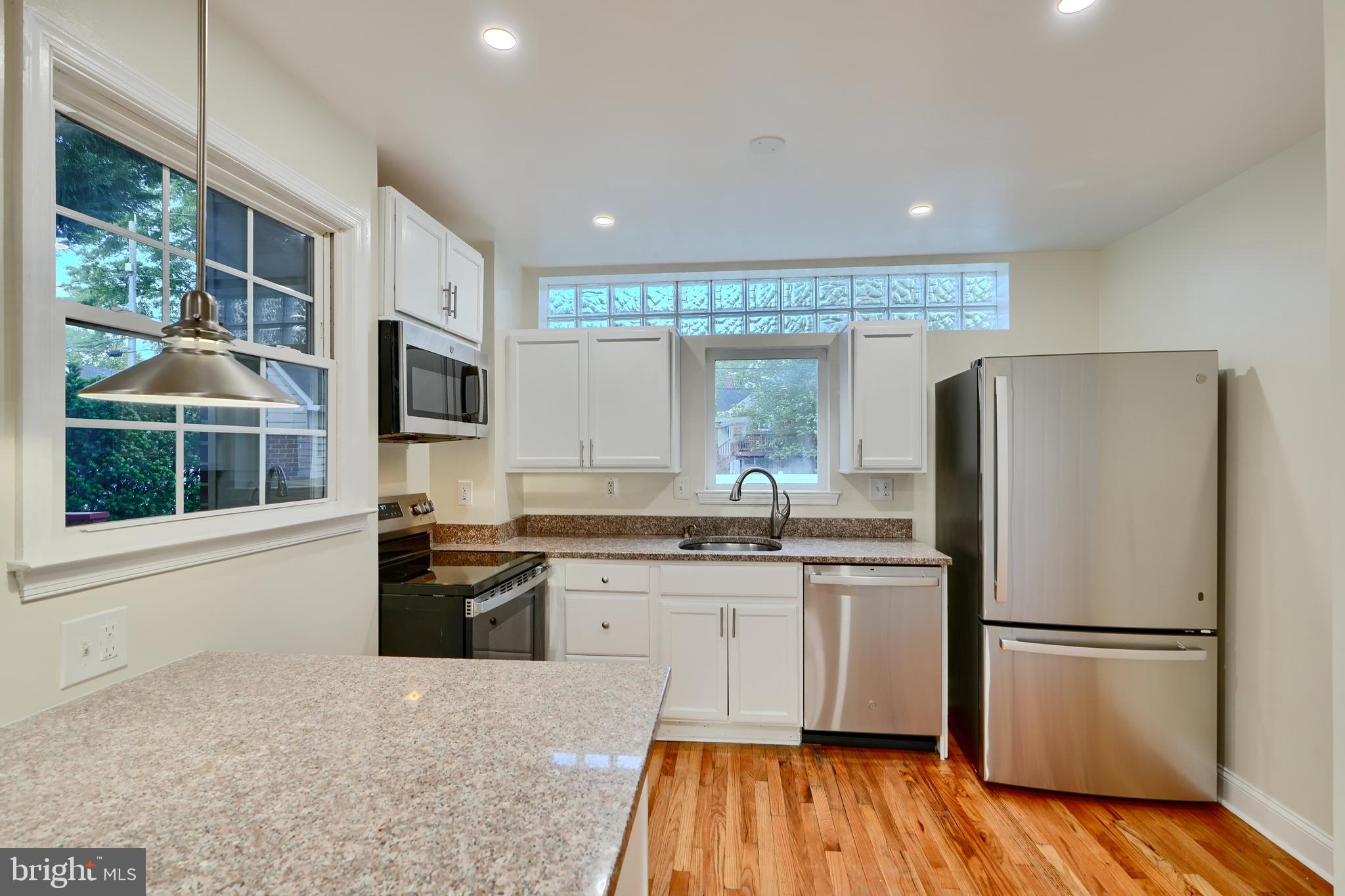 6409 Eastern Parkway Baltimore, MD 21214 - Photo 12 of 56 a kitchen with stainless steel appliances granite countertop a refrigerator a stove top oven a sink and dishwasher