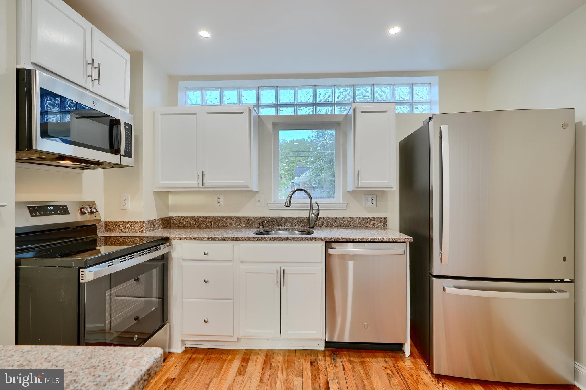 6409 Eastern Parkway Baltimore, MD 21214 - Photo 14 of 56 a kitchen with a refrigerator stove and microwave