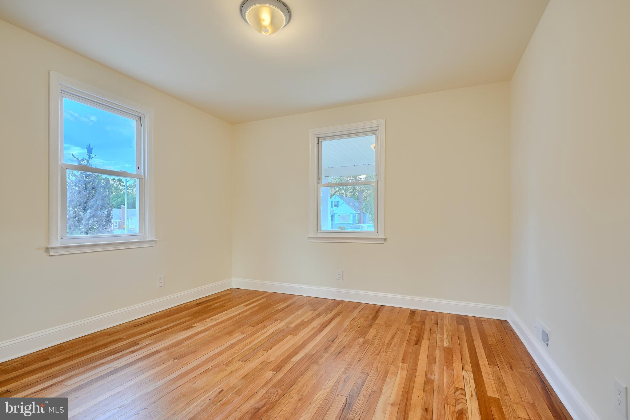 6409 Eastern Parkway Baltimore, MD 21214 - Photo 17 of 56 an empty room with wooden floor and windows