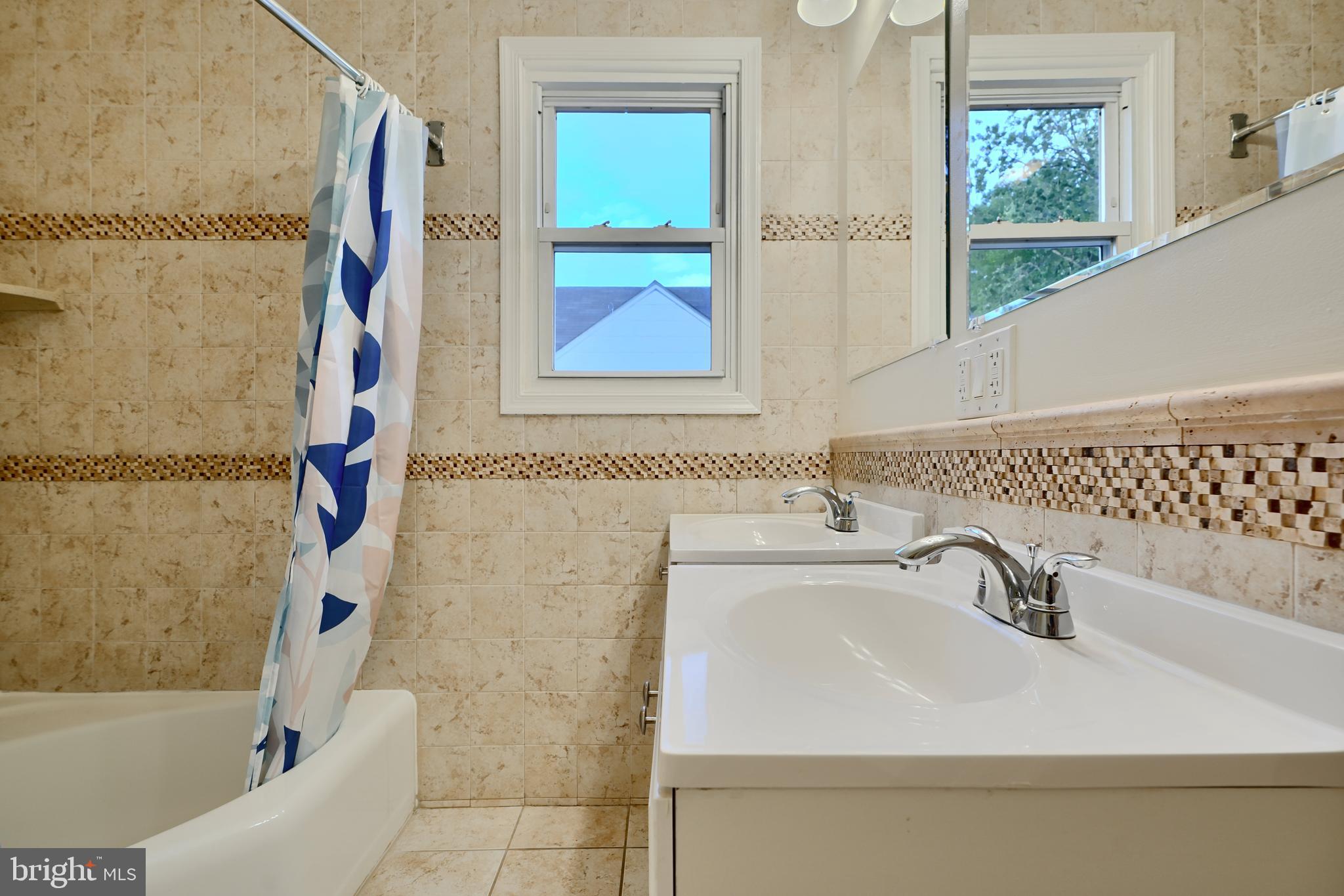 6409 Eastern Parkway Baltimore, MD 21214 - Photo 21 of 56 a bathroom with a sink and a bathtub