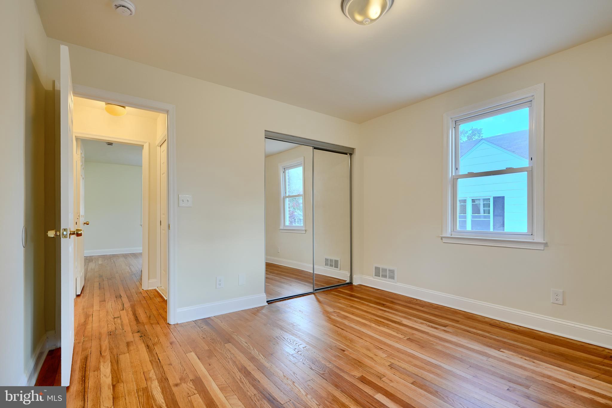 6409 Eastern Parkway Baltimore, MD 21214 - Photo 23 of 56 wooden floor in an empty room with a window