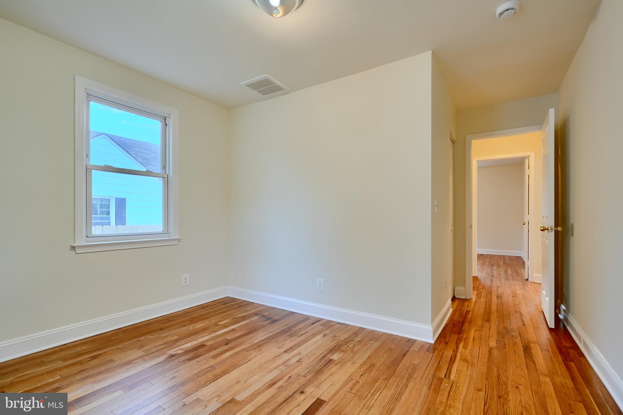 6409 Eastern Parkway Baltimore, MD 21214 - Photo 26 of 56 a view of a room with wooden floor and a window