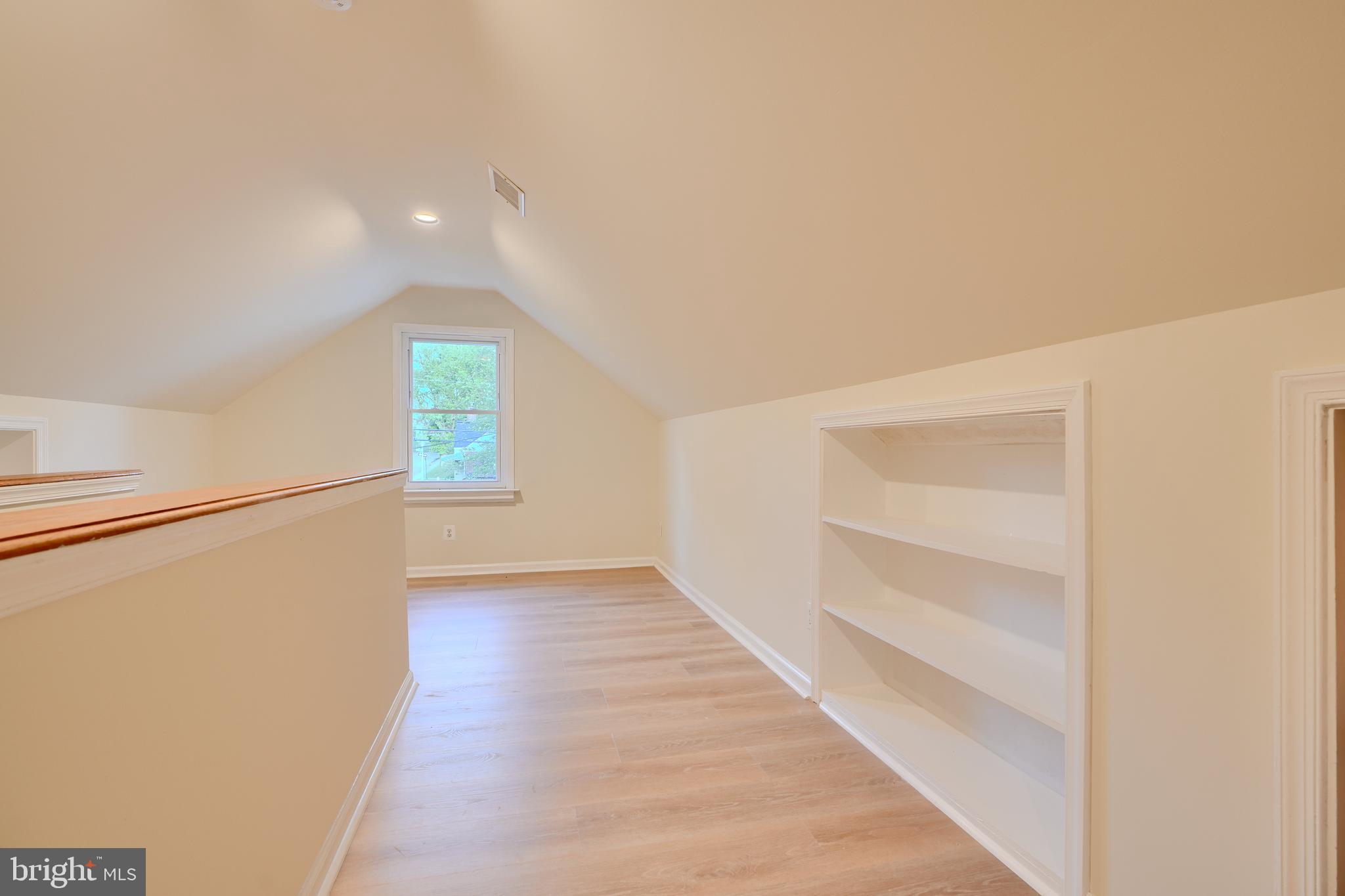 6409 Eastern Parkway Baltimore, MD 21214 - Photo 29 of 56 a view of an empty room with a window and wooden floor