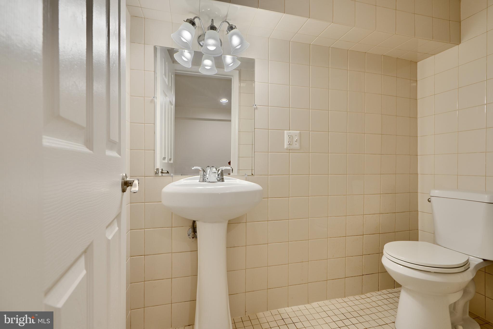 6409 Eastern Parkway Baltimore, MD 21214 - Photo 39 of 56 a bathroom with a sink toilet and shower