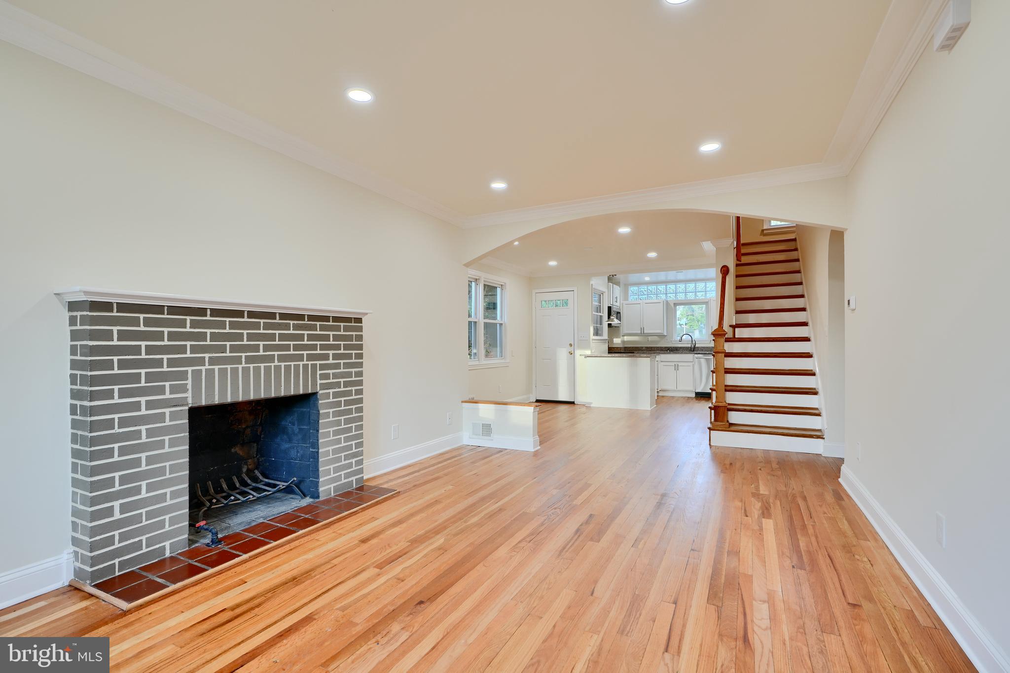 6409 Eastern Parkway Baltimore, MD 21214 - Photo 5 of 56 a view of a hallway with wooden floor and a fireplace