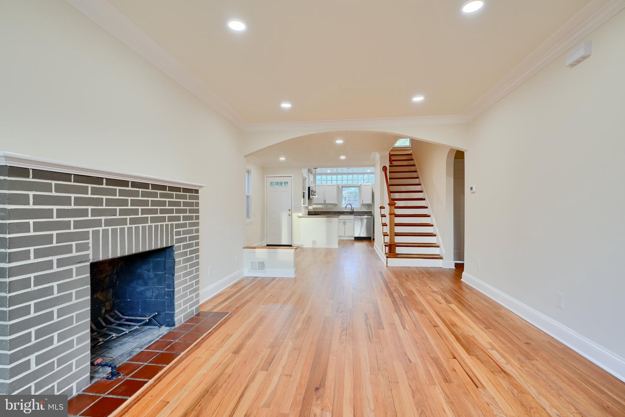 6409 Eastern Parkway Baltimore, MD 21214 - Photo 6 of 56 a view of a room with wooden floor and fireplace