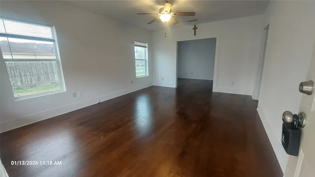 wooden floor in an empty room with a window