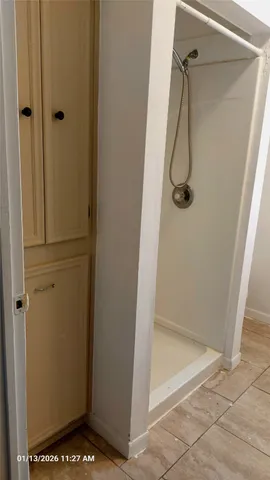 a bathroom with a glass shower door