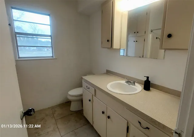 a bathroom with a toilet sink and mirror