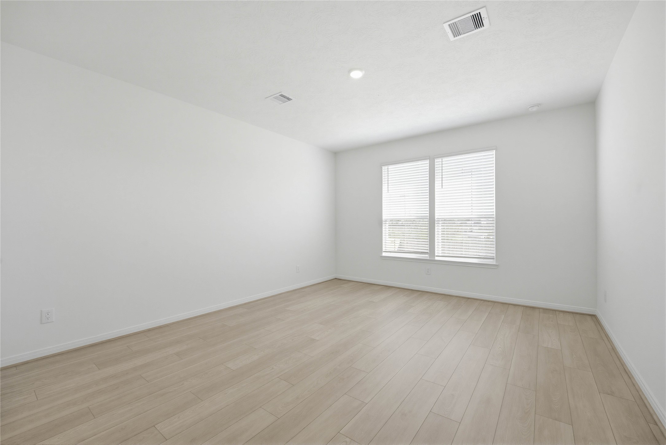 3530 Dryer Park Drive Spring, TX 77373 - Photo 15 of 31 Come and unwind after a long day in this magnificent primary suite! This spacious room features vinyl plank flooring, neutral paint, high ceilings and large windows with privacy blinds.