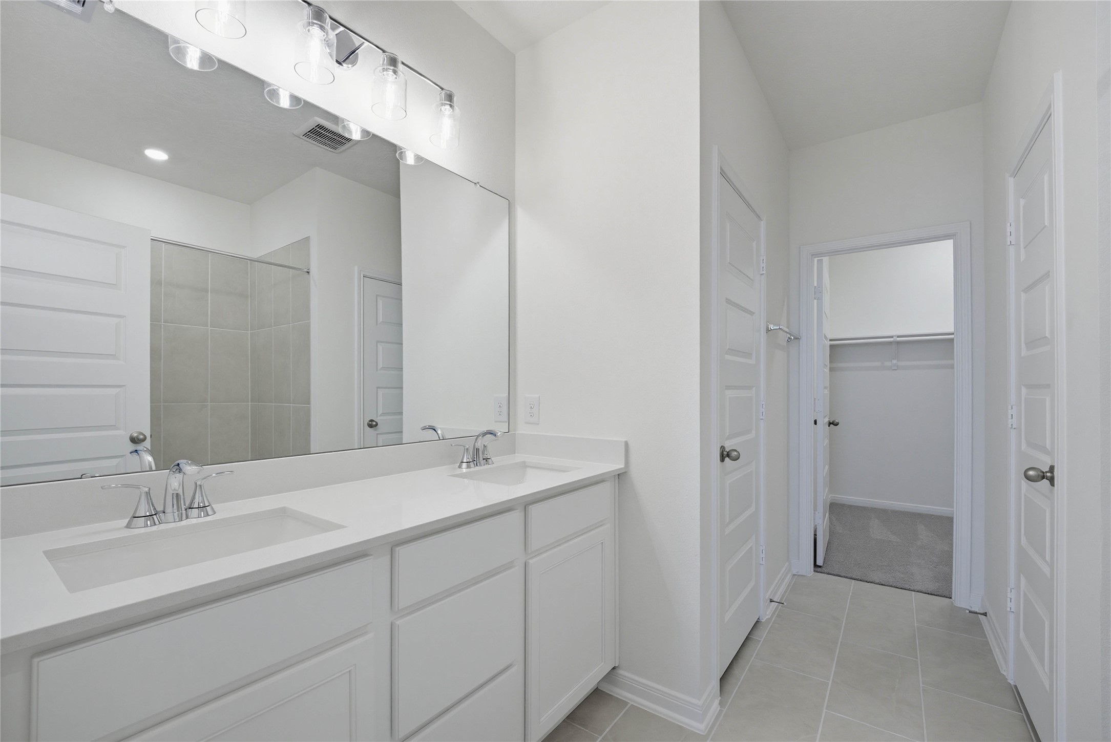 3530 Dryer Park Drive Spring, TX 77373 - Photo 17 of 31 This primary bathroom is definitely move-in ready! Featuring stained cabinets with light countertops, dual vanities, high ceilings, neutral paint, walk-in closet, sleek and modern finishes.
