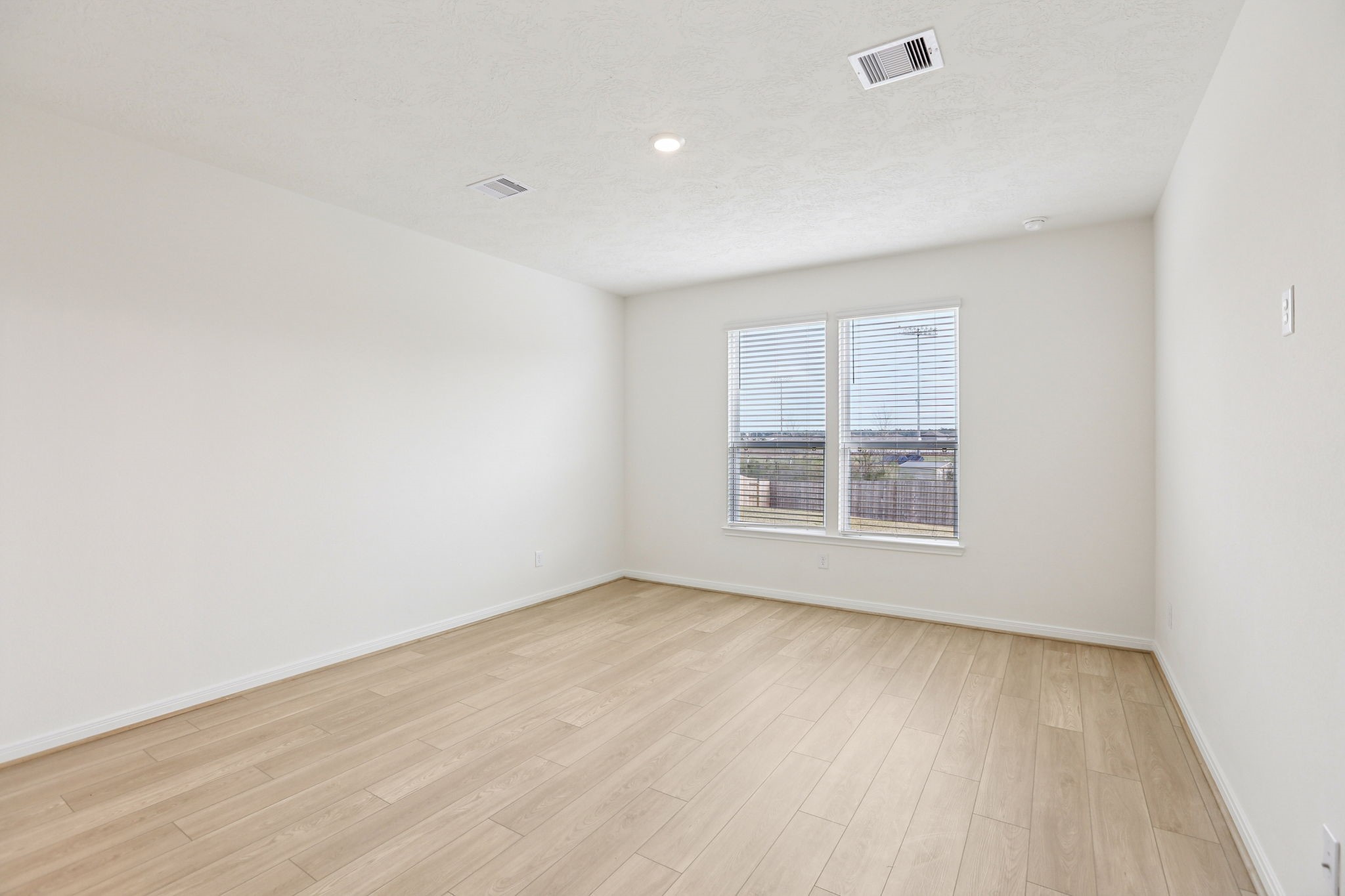 3530 Dryer Park Drive Spring, TX 77373 - Photo 22 of 48 Come and unwind after a long day in this magnificent primary suite! This spacious room features vinyl plank flooring, neutral paint, high ceilings and large windows with privacy blinds.