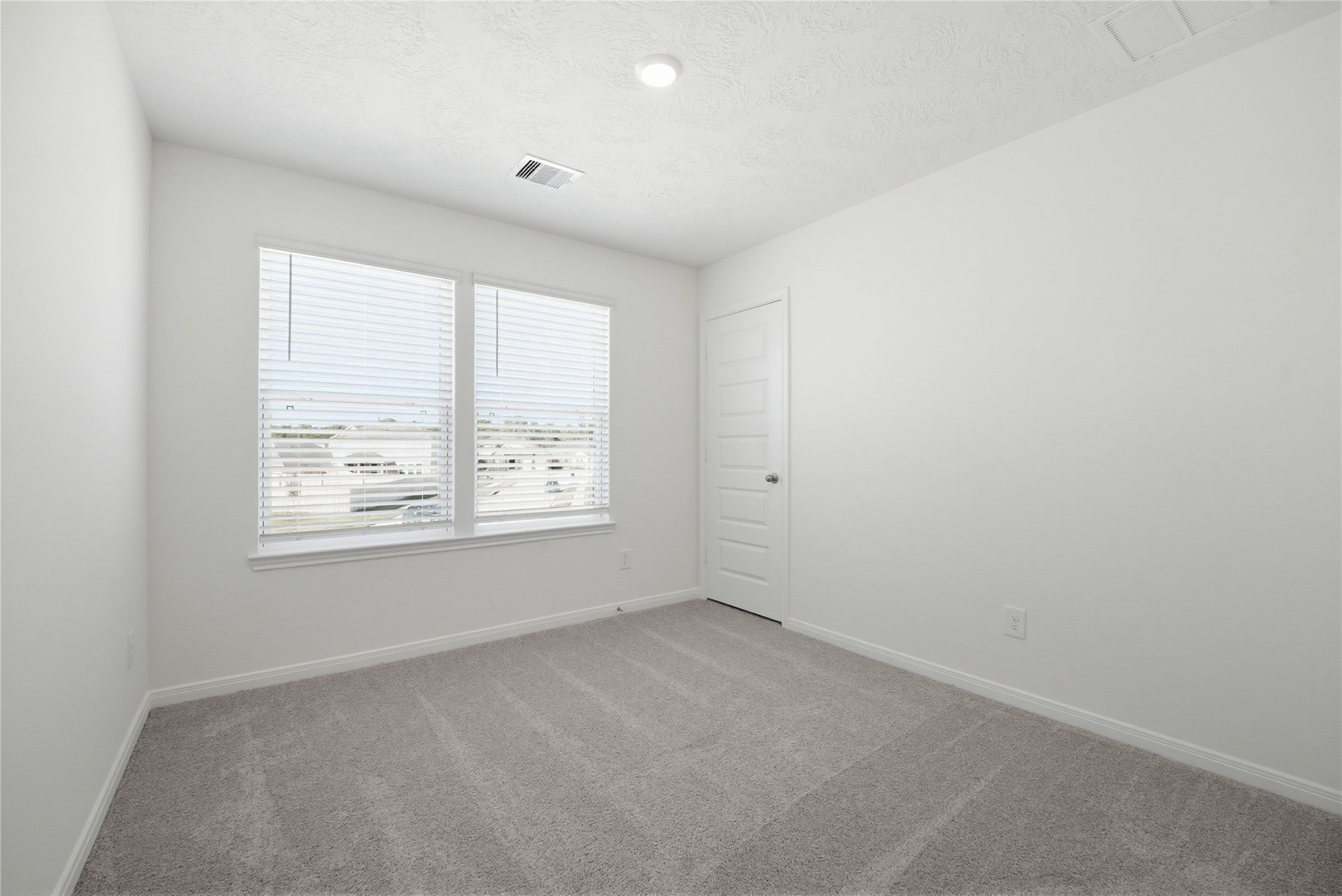 3530 Dryer Park Drive Spring, TX 77373 - Photo 22 of 31 Secondary bedroom features plush carpet, neutral paint, lighting, large windows with privacy blinds, and a walk-in closet.