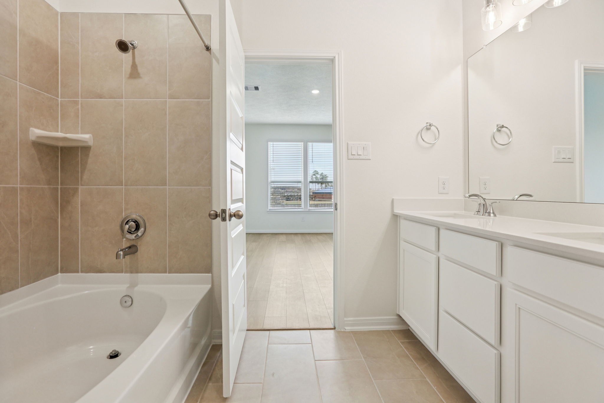 3530 Dryer Park Drive Spring, TX 77373 - Photo 27 of 48 This view highlights the primary bathroom's versatile tub/shower combination, thoughtfully designed to accommodate both a quick, invigorating morning shower and a luxurious, deep soak after a long day.