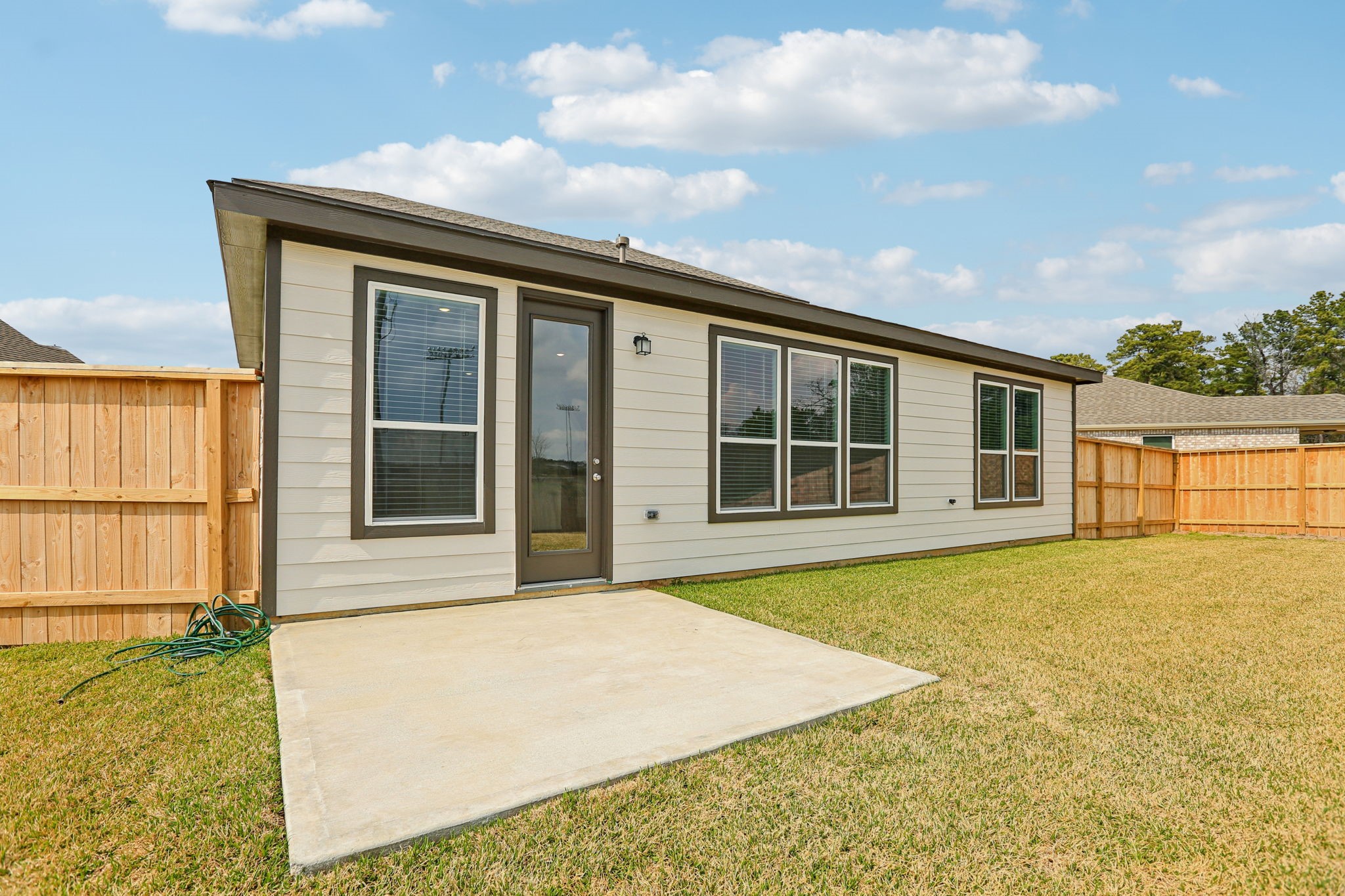 3530 Dryer Park Drive Spring, TX 77373 - Photo 39 of 48 The functional concrete patio slab serves as an ideal base for al-fresco dining, a barbecue setup, or a comfortable lounge area to enjoy the outdoors.