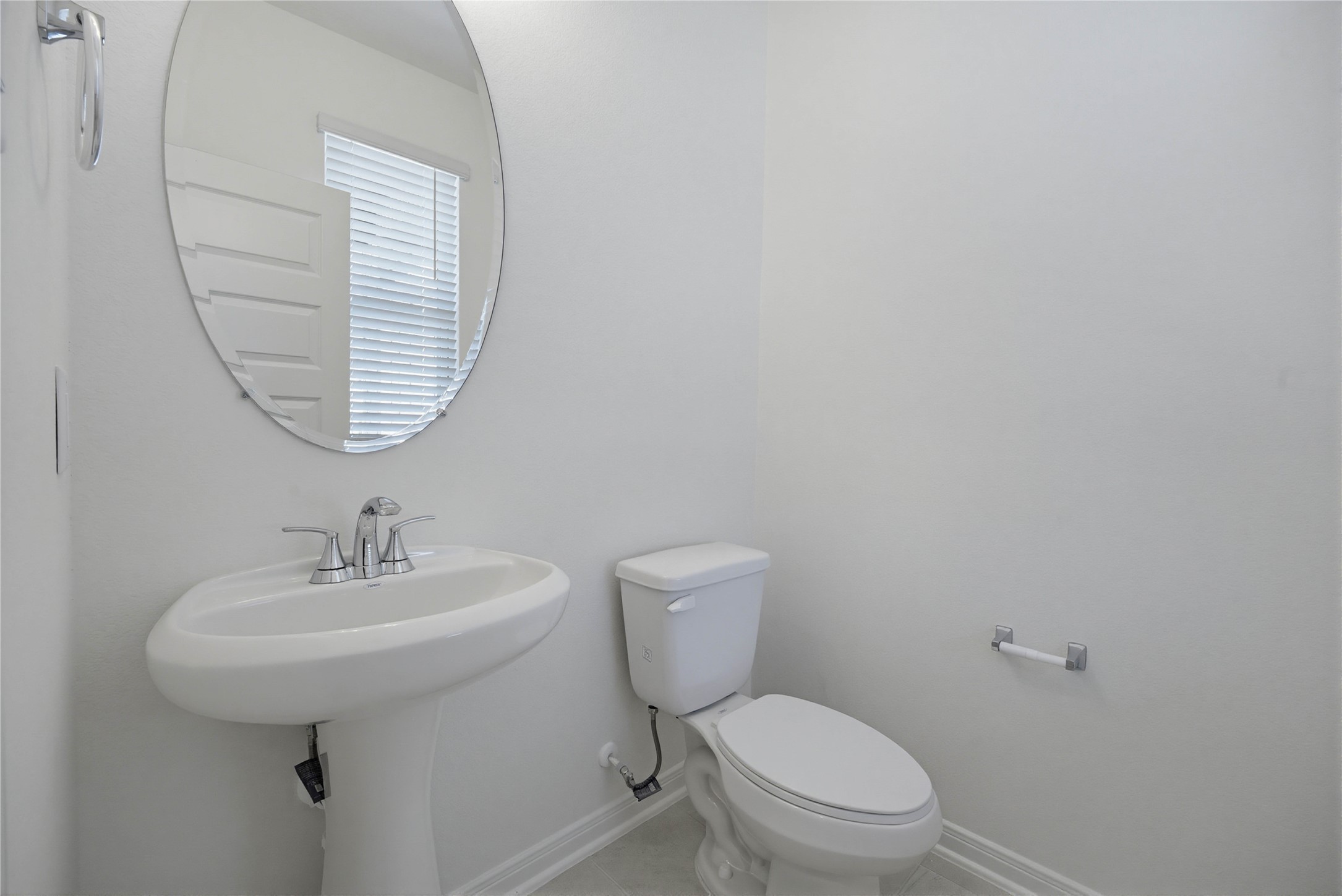 3530 Dryer Park Drive Spring, TX 77373 - Photo 6 of 31 The powder room on the first floor includes a pedestal sink, oval mirror, and toilet to conveniently meet your needs.