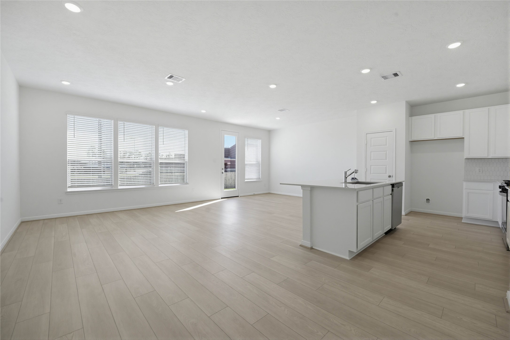 3530 Dryer Park Drive Spring, TX 77373 - Photo 8 of 31 Flooded with natural light from large windows and a patio door, the Great Room feels bright and airy. Recessed lighting adds to the welcoming atmosphere, perfect for gathering with family and guests.
