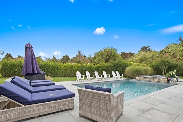 a view of a terrace with couches and wooden fence