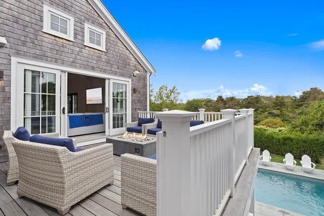 a view of a roof deck with couches and sky view