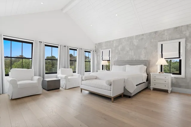 a bedroom with a large bed and a couch